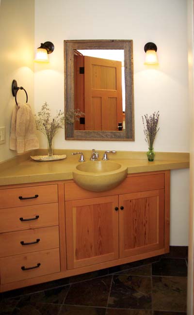 
Custom cabinets and concrete countertops add style to Ed and Shannon’s sustainable bathroom.
